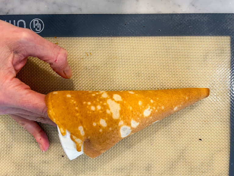 Hand shaping a homemade ice cream cone