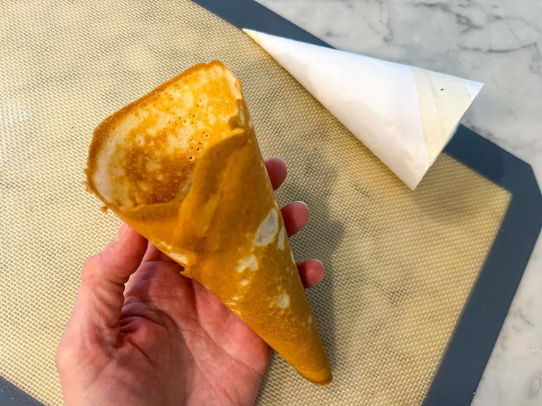 Hand holding a homemade ice cream cone