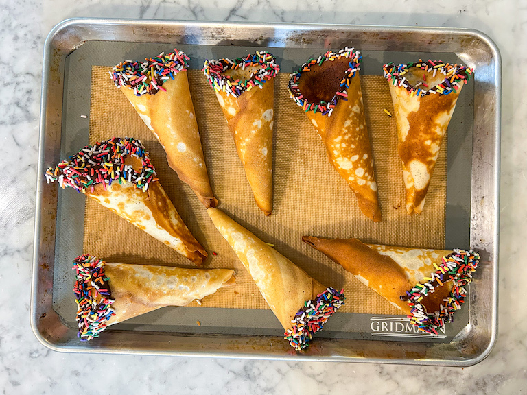 Chocolate dipped ice cream cones on a tray