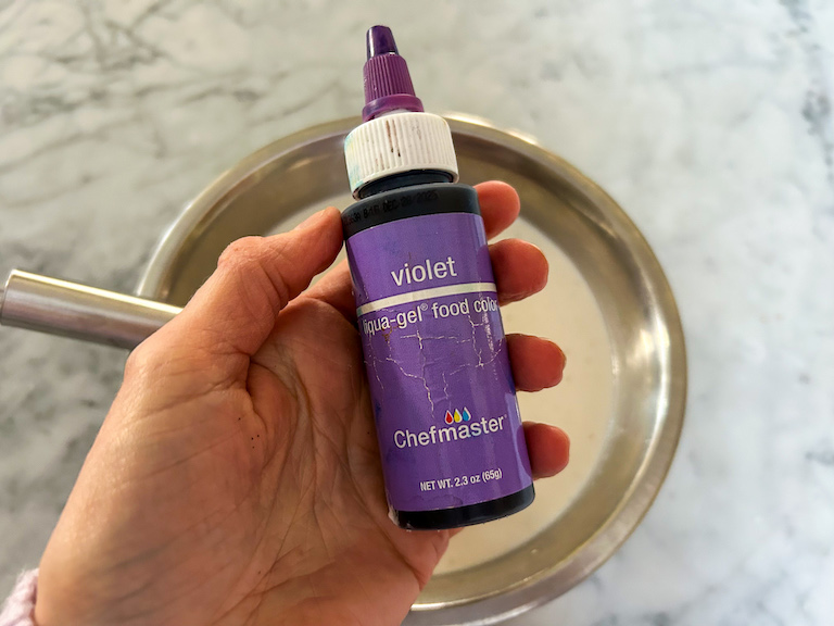 Hand holding a bottle of gel food coloring