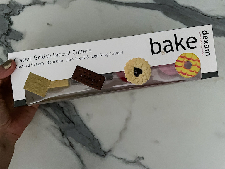 Hand holding a box of biscuit cutters