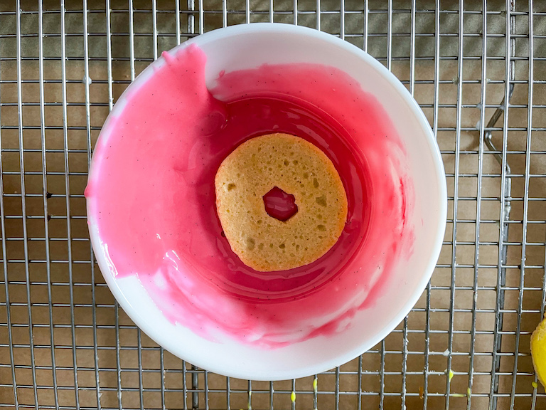 A ring shaped cookie in pink icing