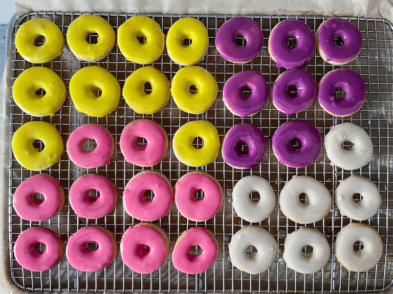 Yellow, purple, pink and white party rings on a rack