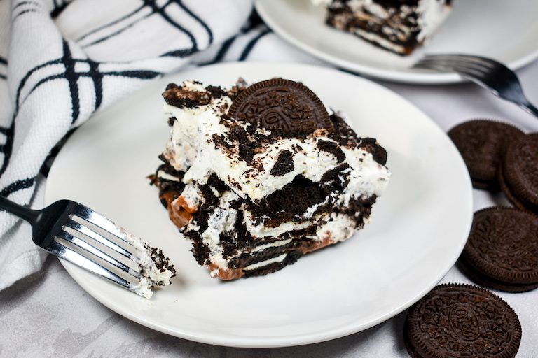 A slice of Oreo icebox cake on a white plate