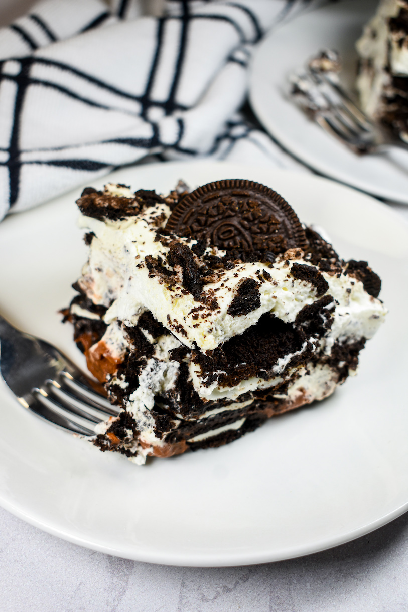 Slice of Oreo icebox cake on a white plate