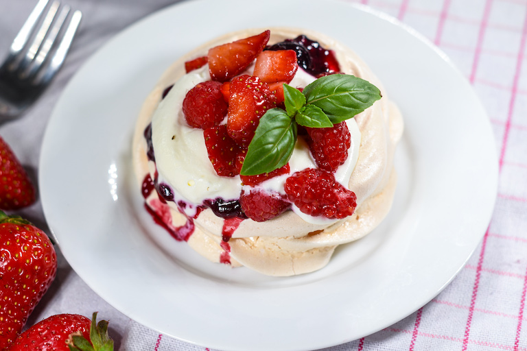 A miniature pavlova on a white plate