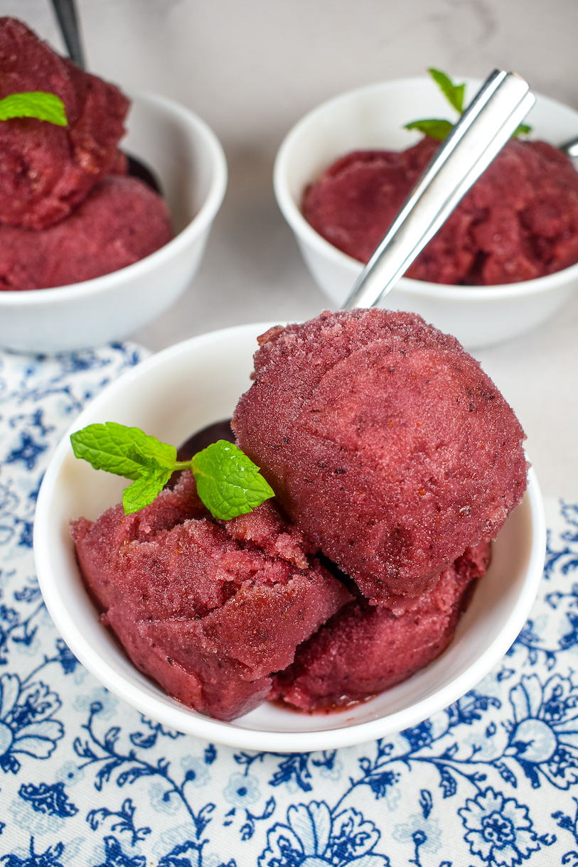 a dish of blueberry sorbet on a blue floral print tea towel