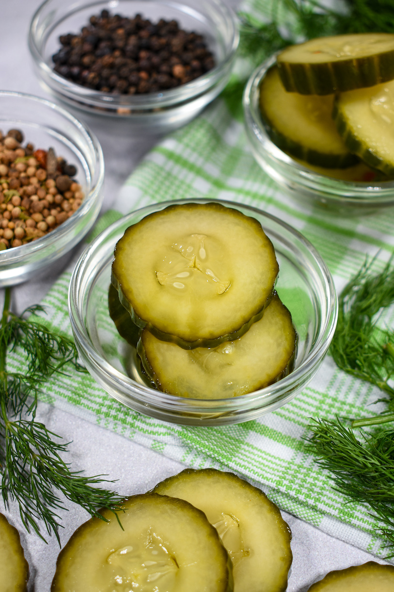 a dish of pickles on a green plaid towel