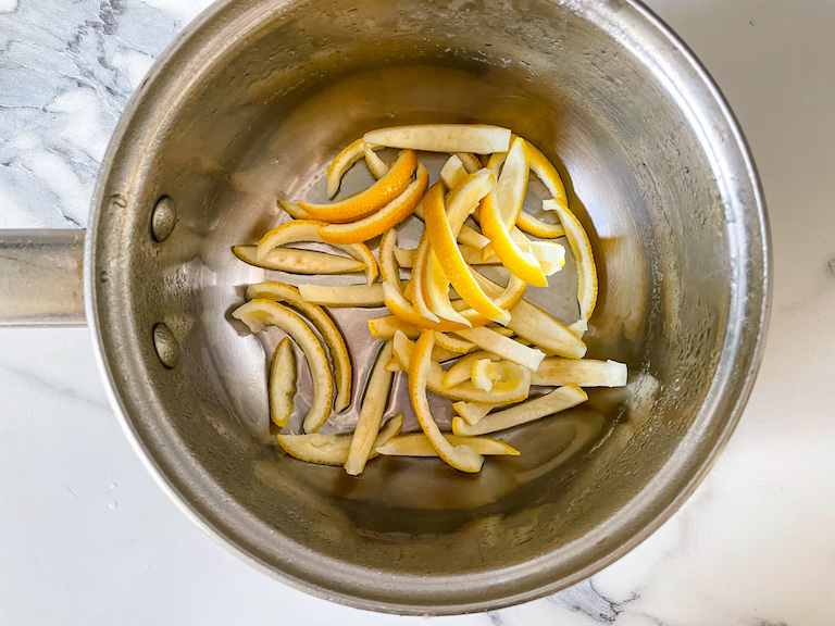 A saucepan of lemon rind strips