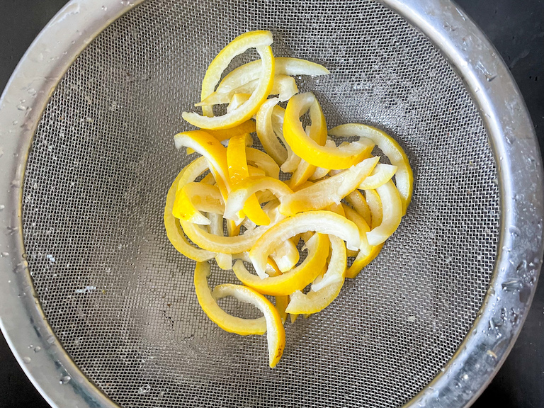 Mesh strainer with blanched lemon slices