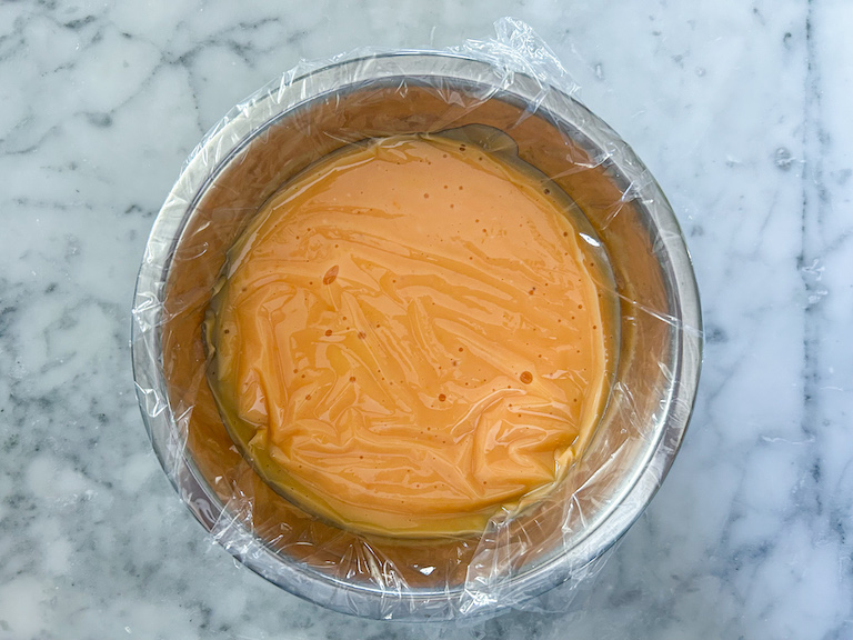 Bowl of grapefruit curd covered with clingfilm