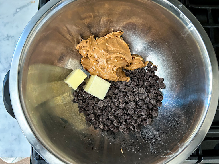 chocolate chips, peanut butter, and butter in a large metal bowl