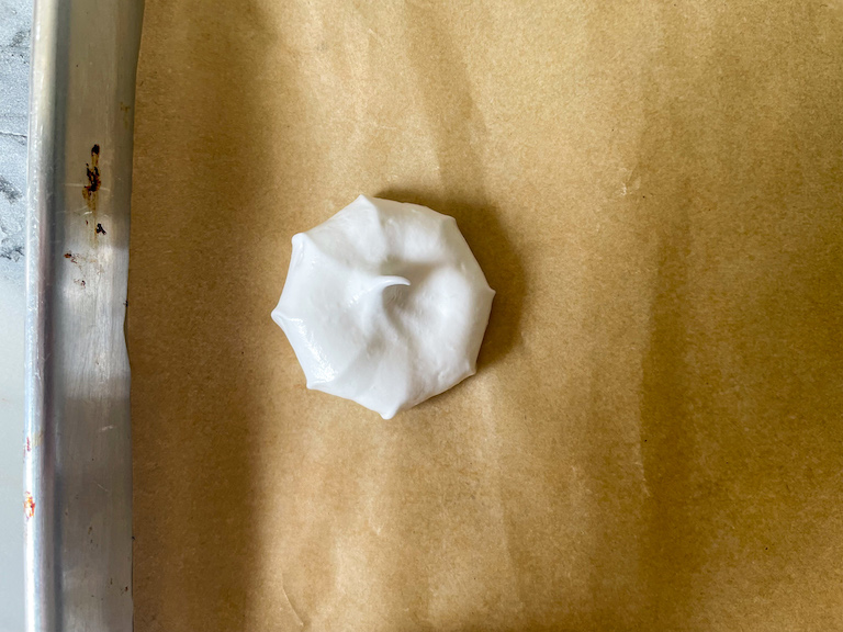 A dollop of meringue on a sheet of parchment