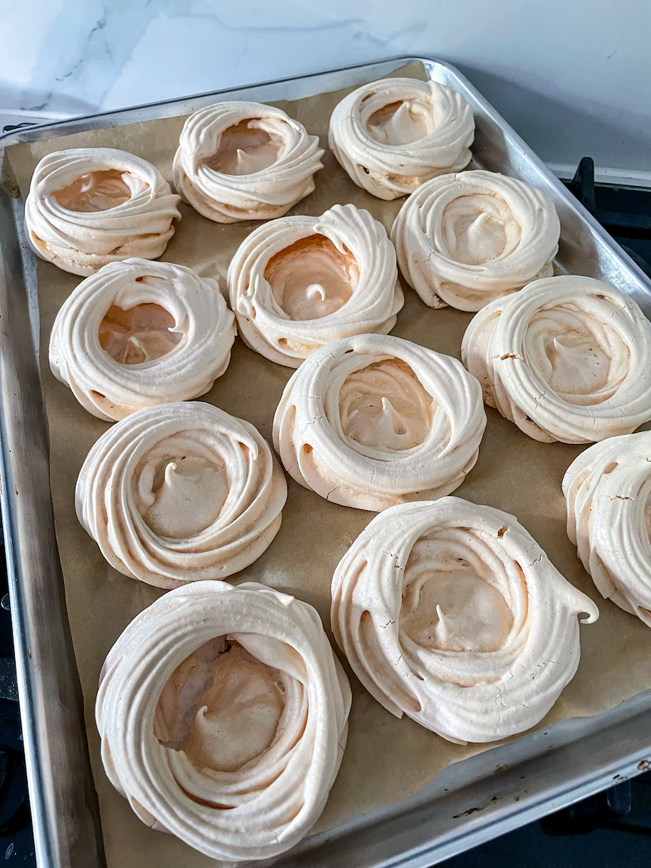 A tray of meringue nests after baking