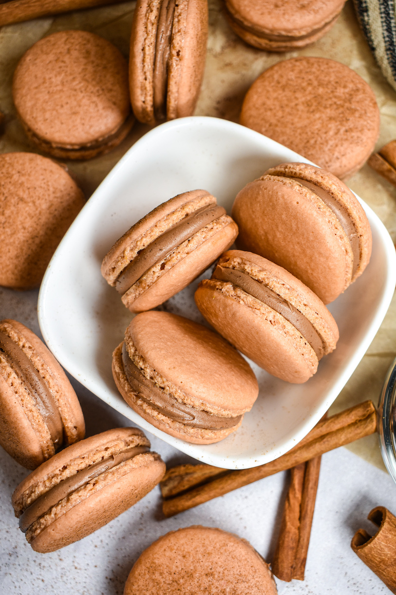 cinnamon chai macarons in a white bowl