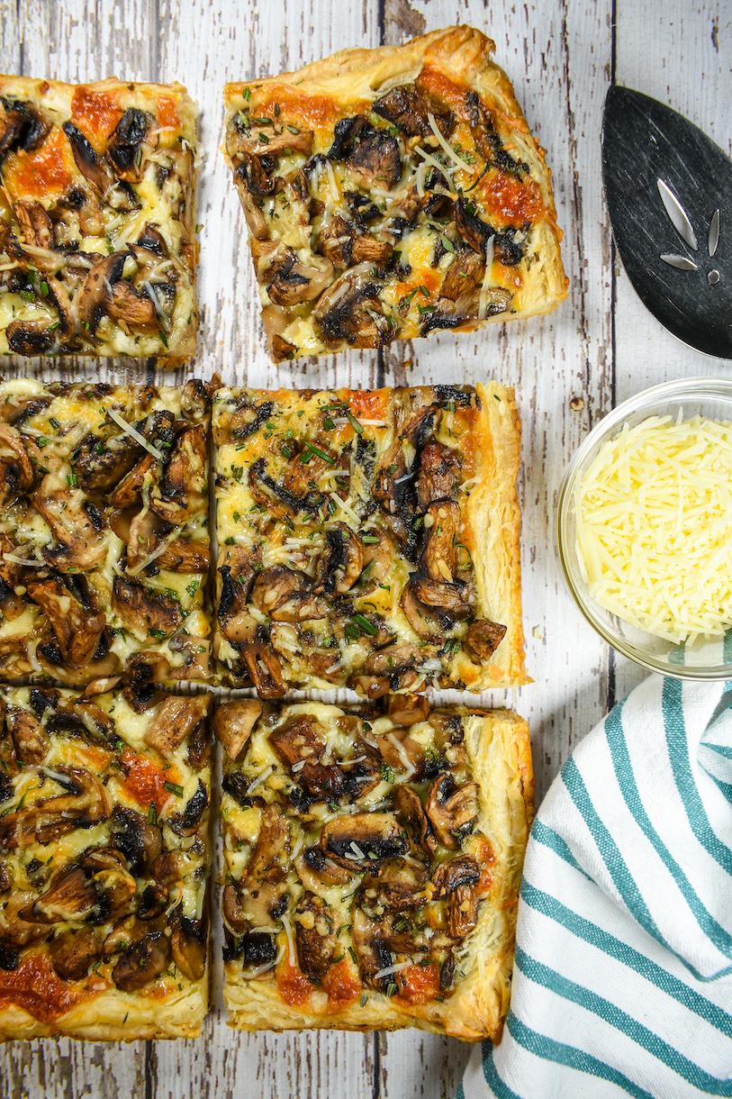 sliced mushroom tart arranged on a white surface