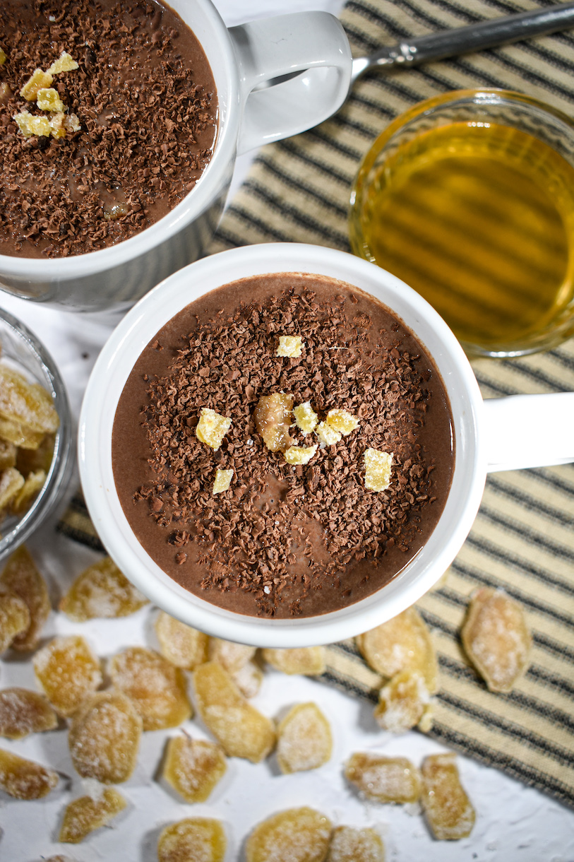 A mug of hot chocolate garnished with bits of candied ginger