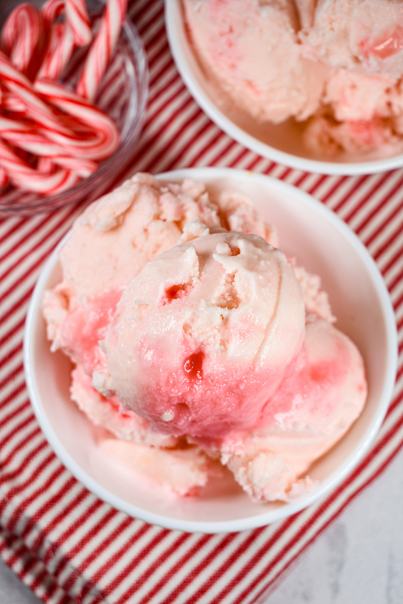 looking down at a bowl of peppermint ice cream on a red striped towel