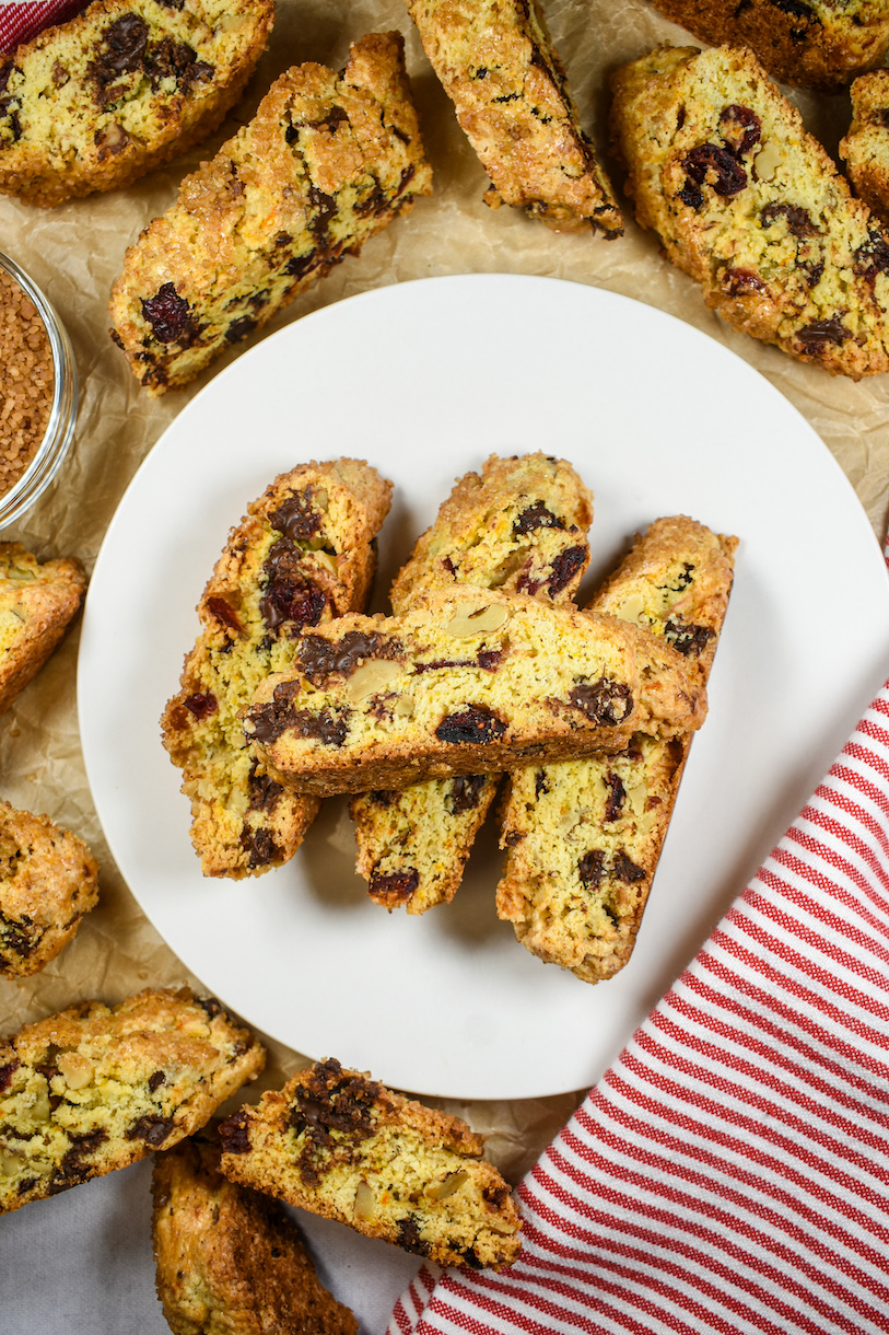 a plate of cranberry biscotti cookies on a sheet of parchment