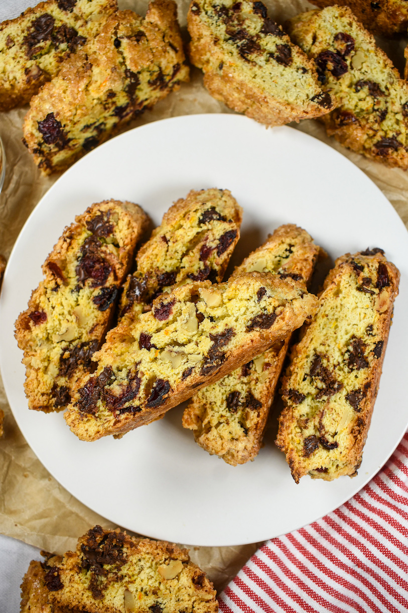 Plate of cranberry and orange biscotti on a sheet of brown parchment
