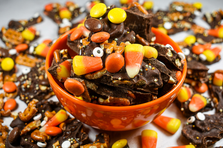An orange plastic bowl filled with chocolate bark