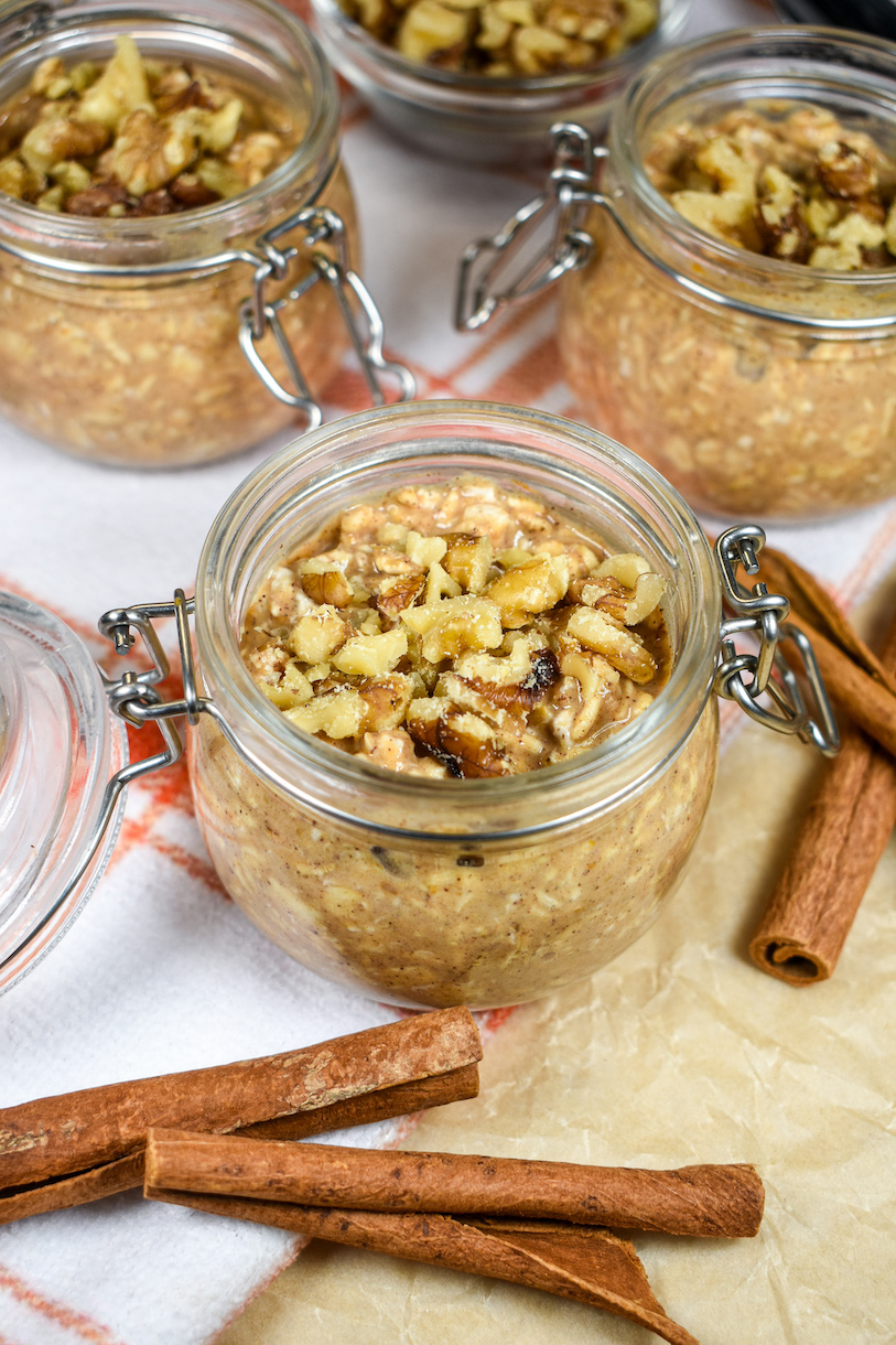 a jar of pumpkin spice overnight oats garnished with walnuts