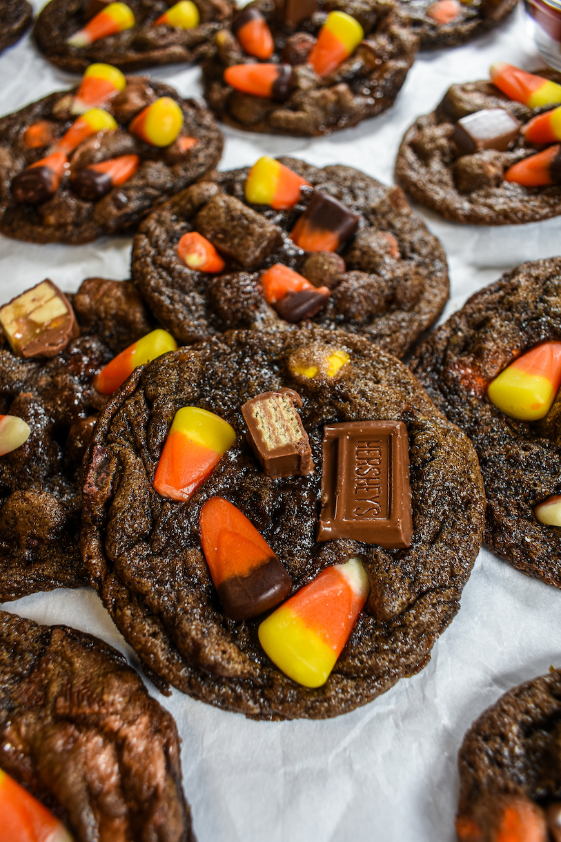 Halloween cookies decorated with candy corn and chopped chocolate bars