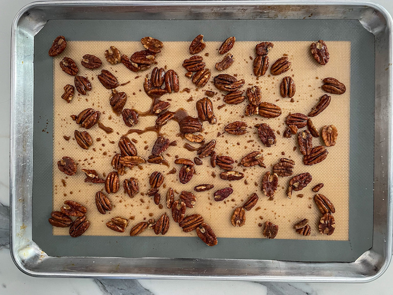 A tray of maple pecans before roasting