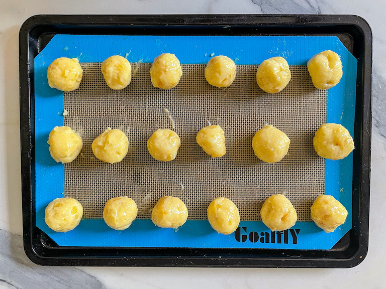 Balls of white chocolate ginger ganache on a tray