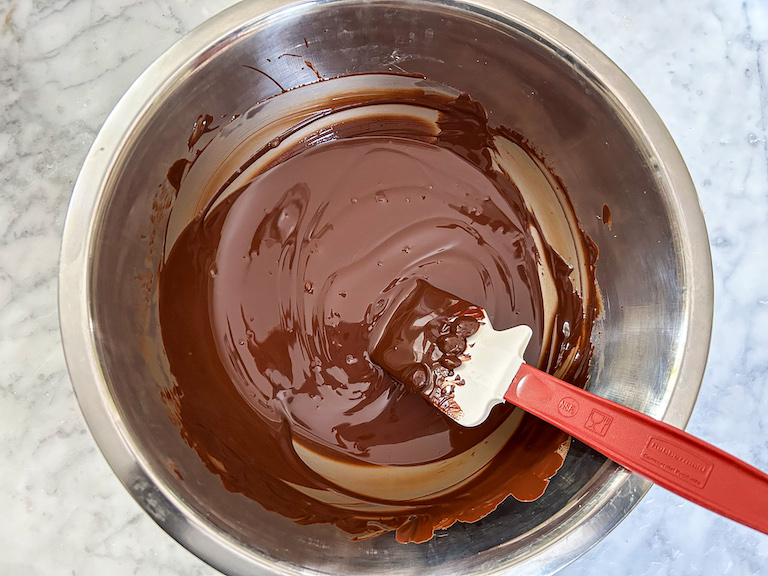 Bowl of melted chocolate with a spatula