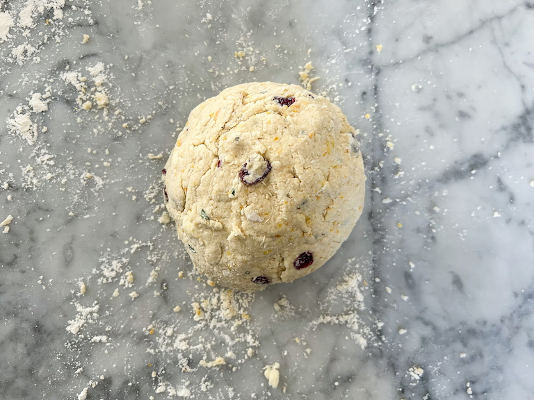 A ball of scone dough on a floured countertop
