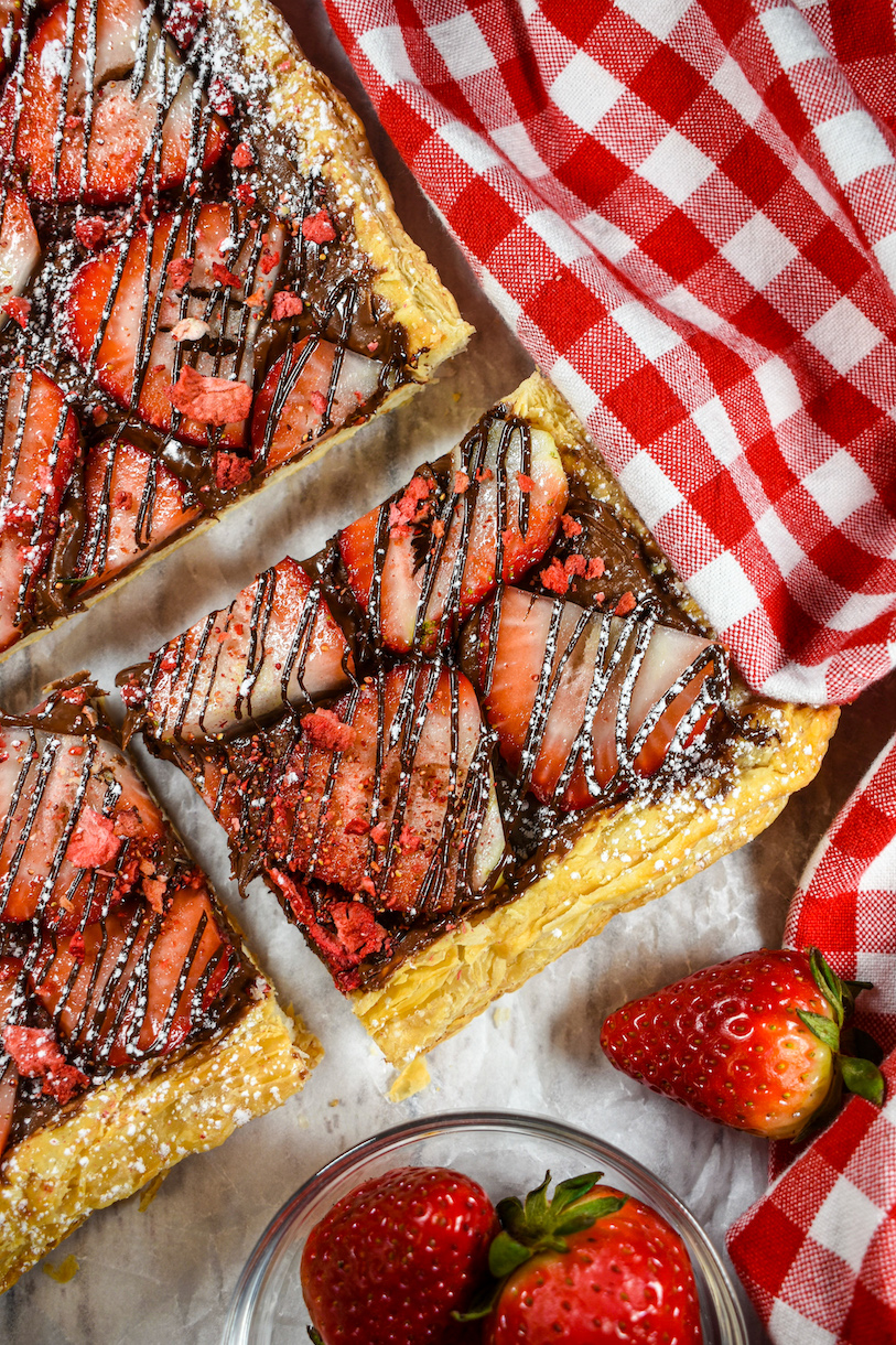 slices of strawberry nutella pizza and a checkered red tea towel