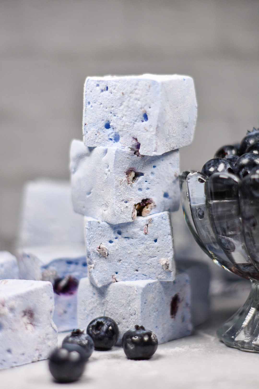 a stack of blueberry marshmallows and a dish of blueberries