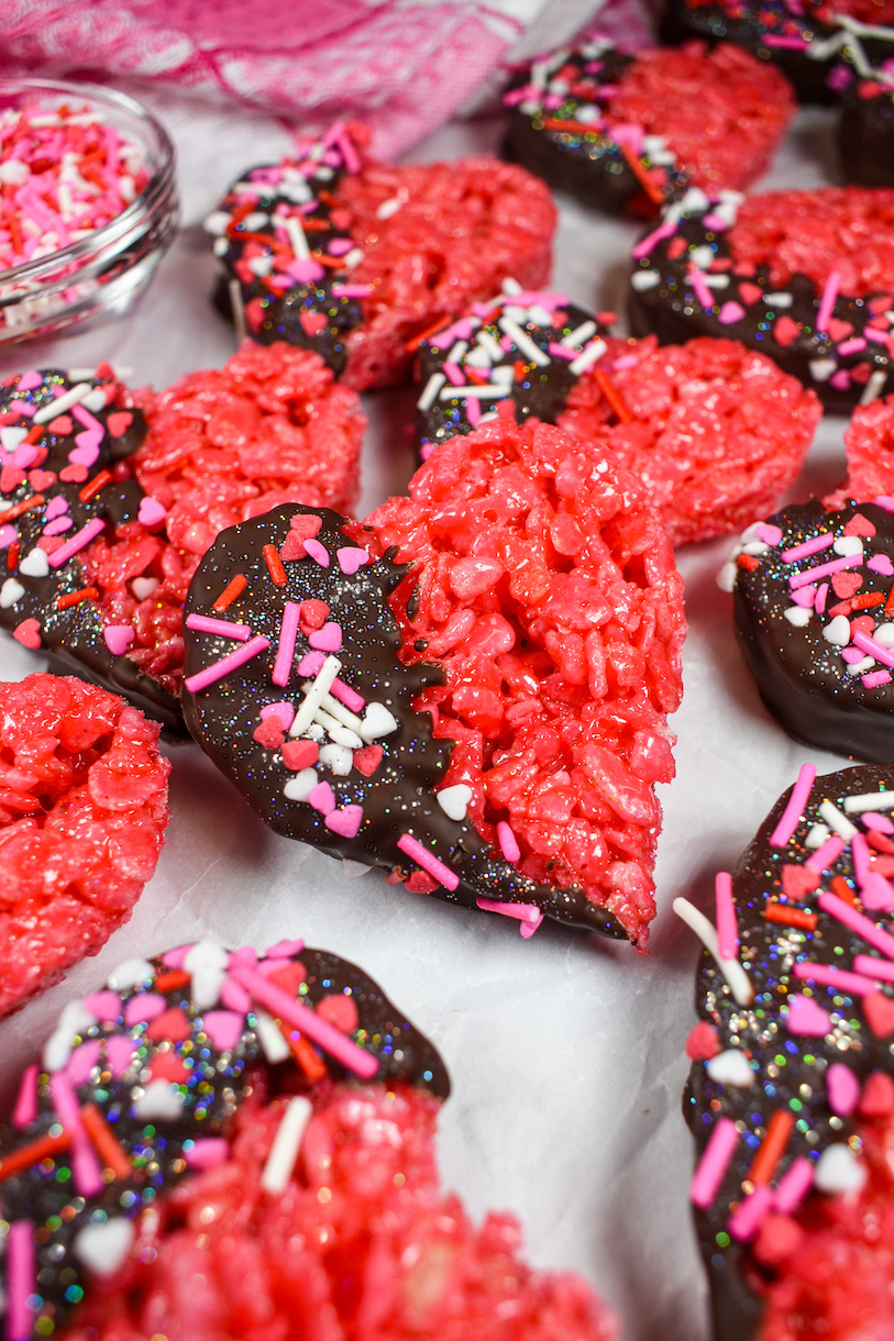 a red heart shaped krispie treat on a white surface