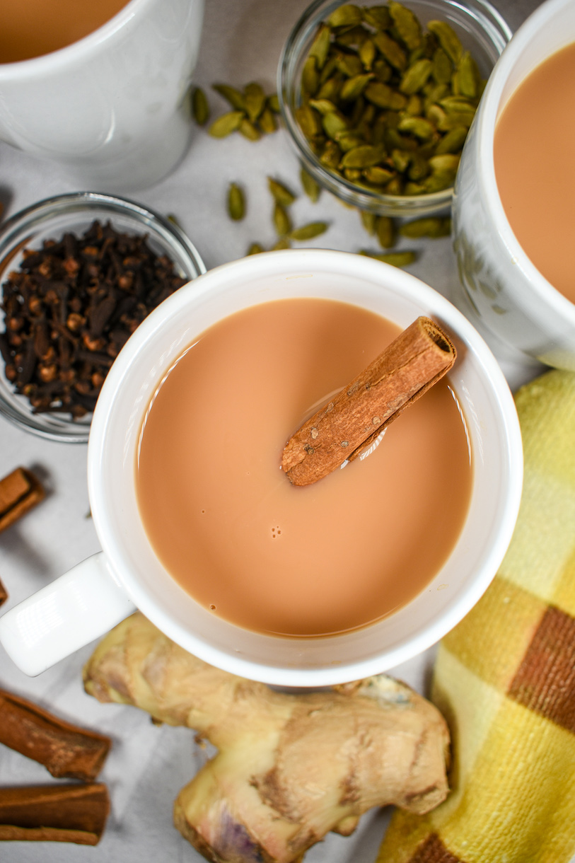 a mug of cardamom tea with a cinnamon stick