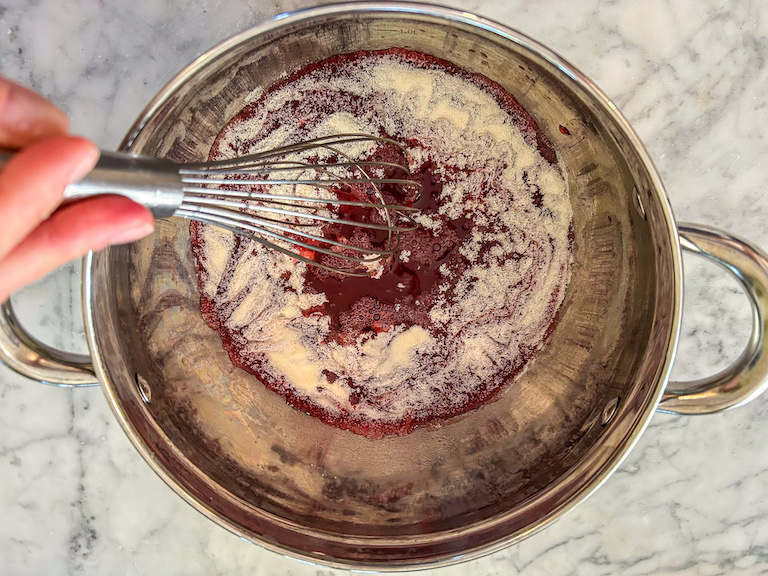 Whisking cranberry juice and gelatin