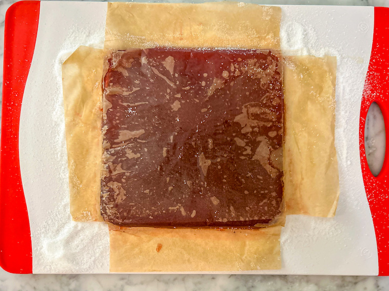 Slab of cranberry candy on a cutting board
