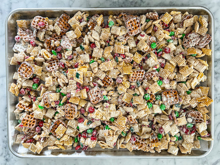 A tray of cereal mix cooling on a marble countertop