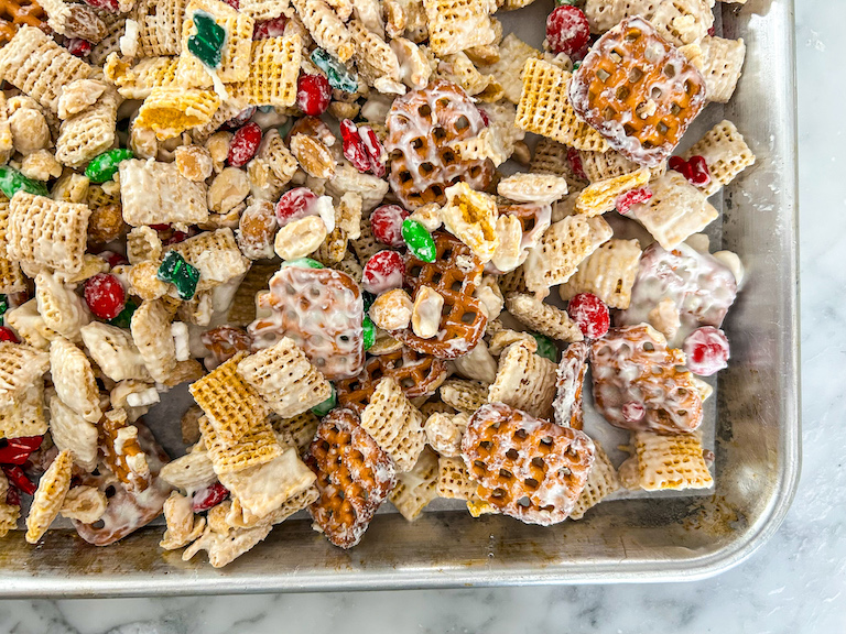 Christmas cereal mix cooling on a metal tray