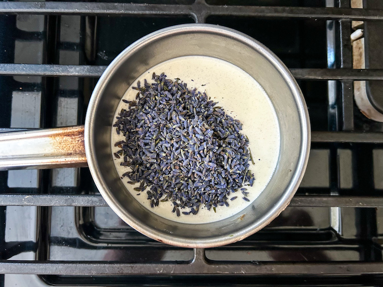 A saucepan of cream with dried lavender sprinkled on top