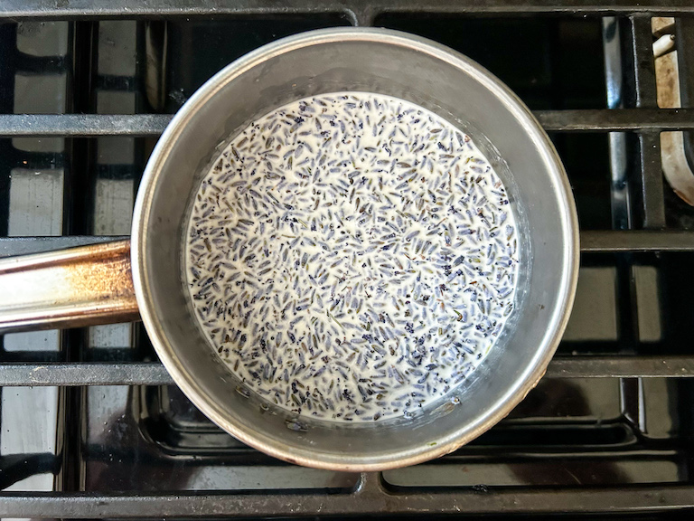 A pan of cream and lavender buds on the stovetop
