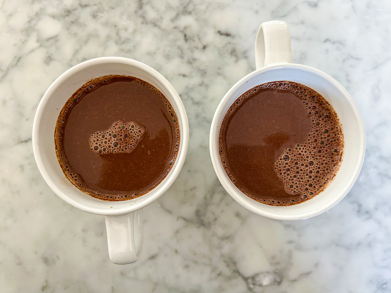Two mugs of lavender hot chocolate