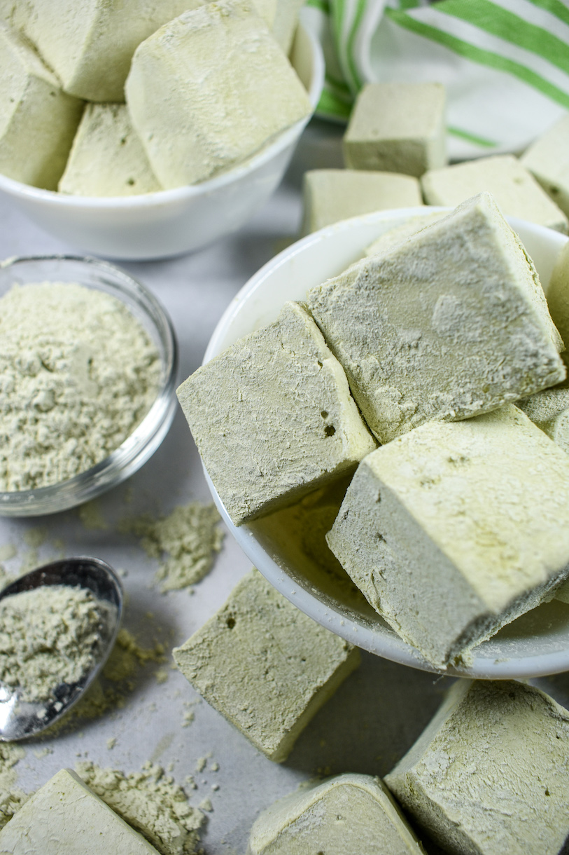 Bowls of matcha marshmallows on a white surface