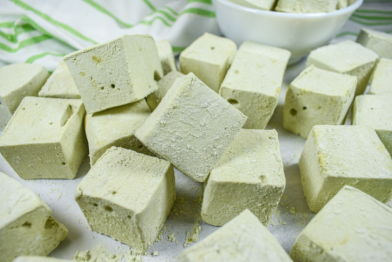 Matcha marshmallows on a white surface