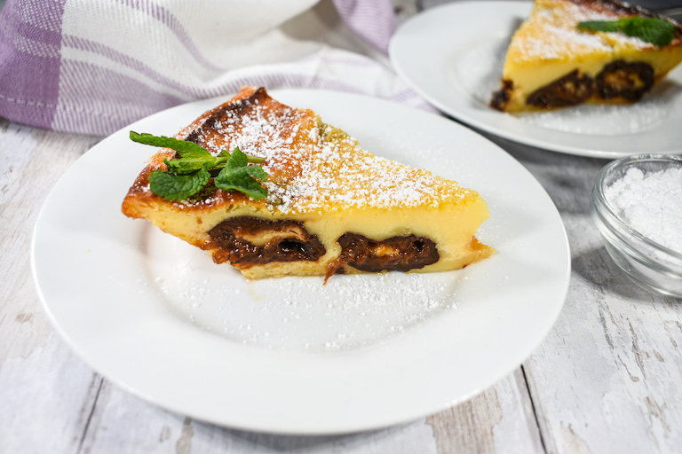 A slice of clafoutis on a white plate