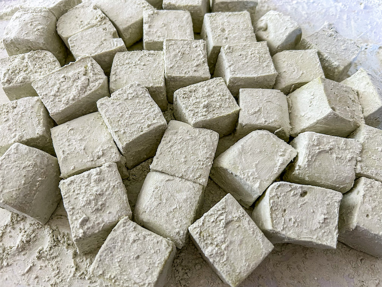 Homemade matcha marshmallows on a white surface