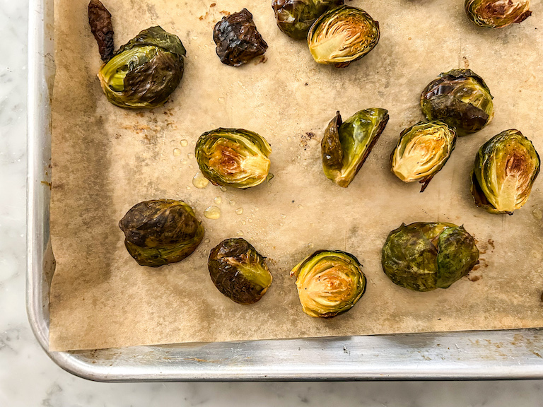 Sprouts roasting on a parchment lined tray
