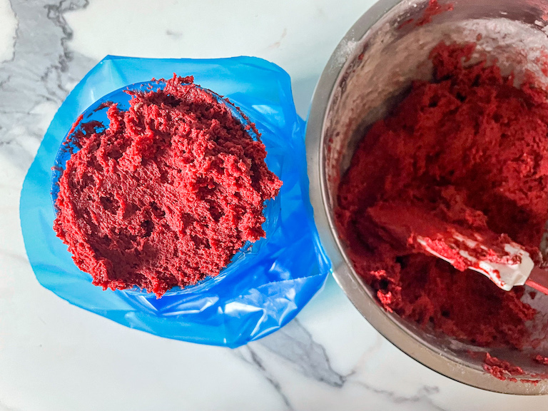 A piping bag filled with red velvet whoopie pie batter
