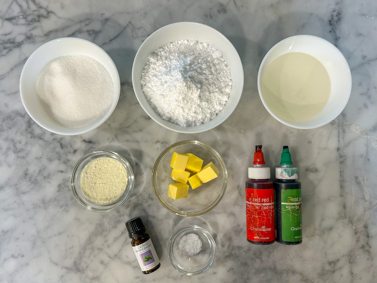 Ingredients for making Christmas candy corn arranged on a marble countertop