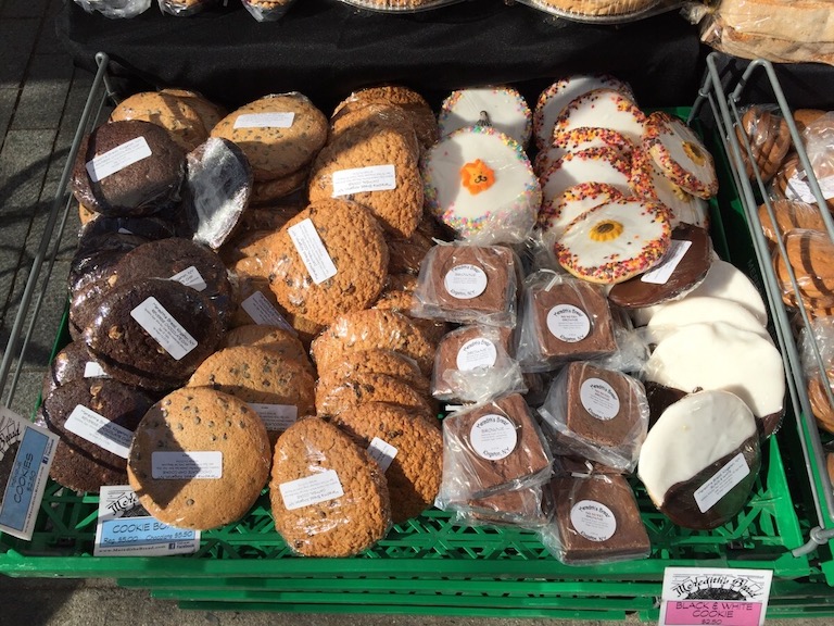 A display of cookies and baked goods for sale at an NYC greenmarket